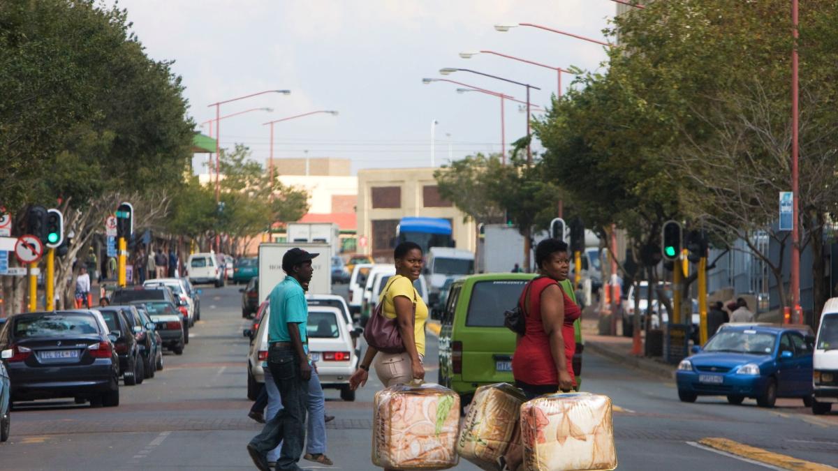 Pessoas atravessando ruas movimentadas em Joanesburgo, África do Sul
